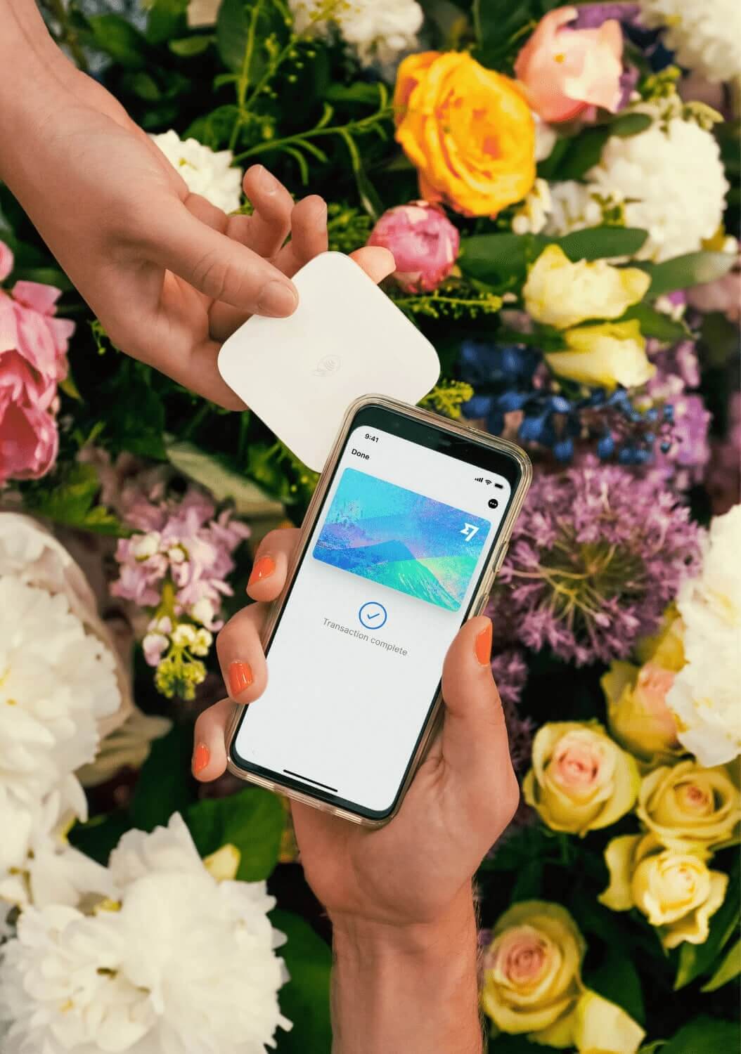 A person holding a phone displaying a digital Wise Multi-Currency Card